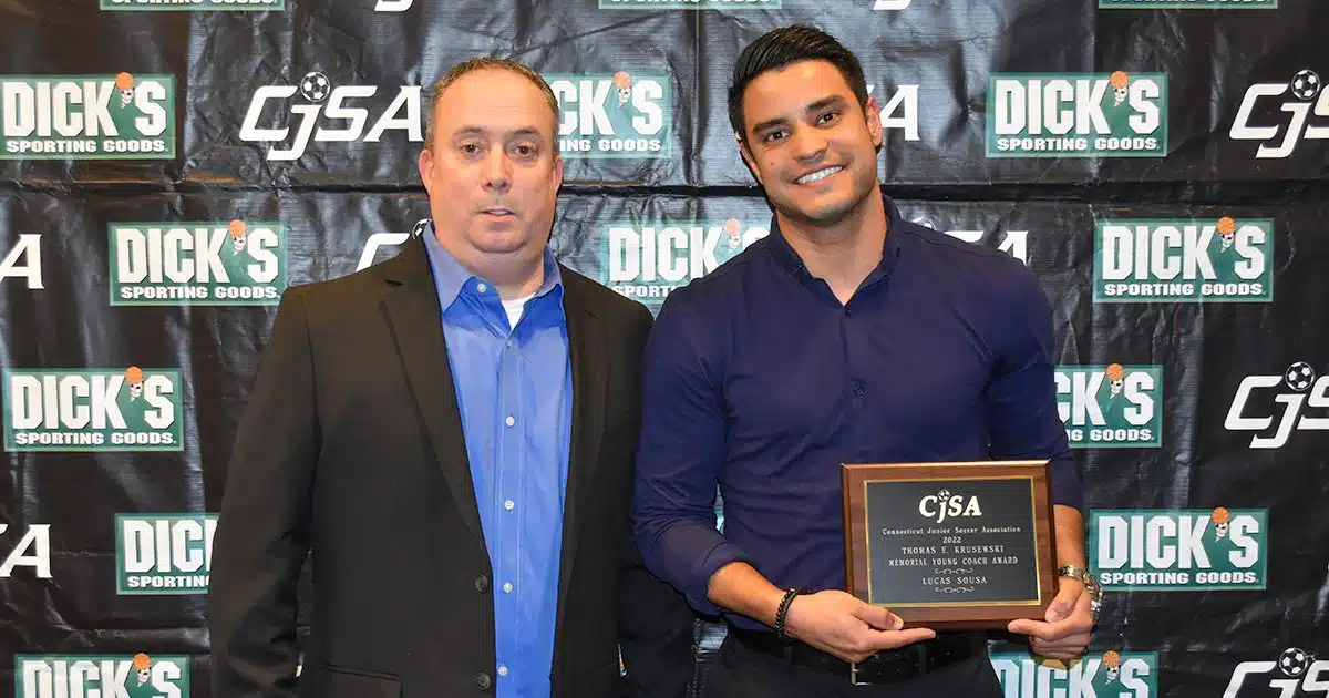 CJSA Executive Director Josh Kruseski takes a photo with the winner of the Connecticut Young Coach Award.