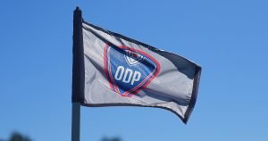 A flag for US Youth Soccer's Olympic Development Program waves in the wind.