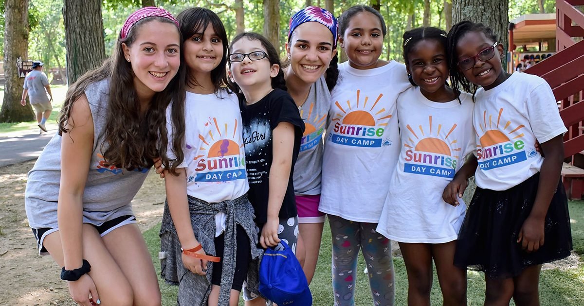 A group poses for a phot at a Sunrise Association Day Camp.